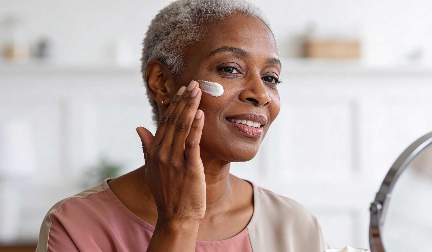 Woman applying First Lady GlutaWhite Collagen Brightening cream to her cheek