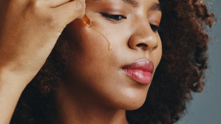 Multi-action brightening serum being applied to skin, targeting dark spots and fine lines