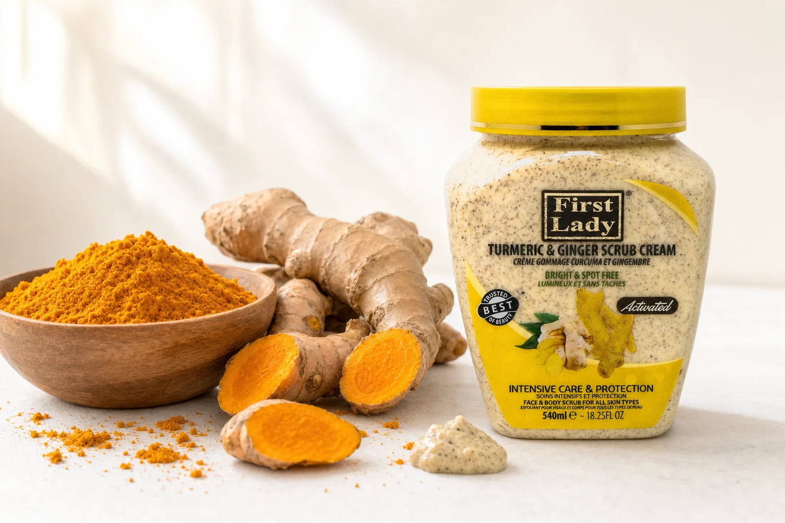 First Lady Turmeric & Ginger Scrub Cream jar beside fresh turmeric, ginger root and turmeric powder